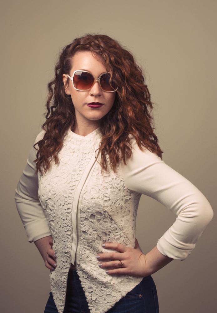 Fashion portrait with sunglasses and white jacket