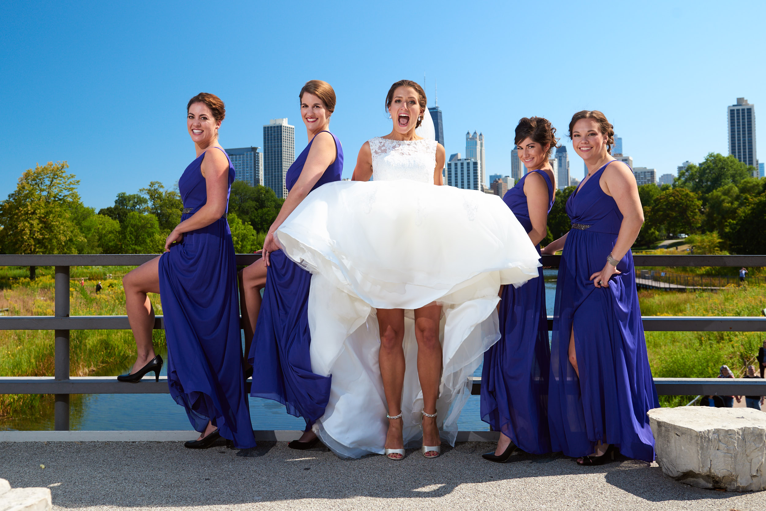Jumping bride with bridesmaids