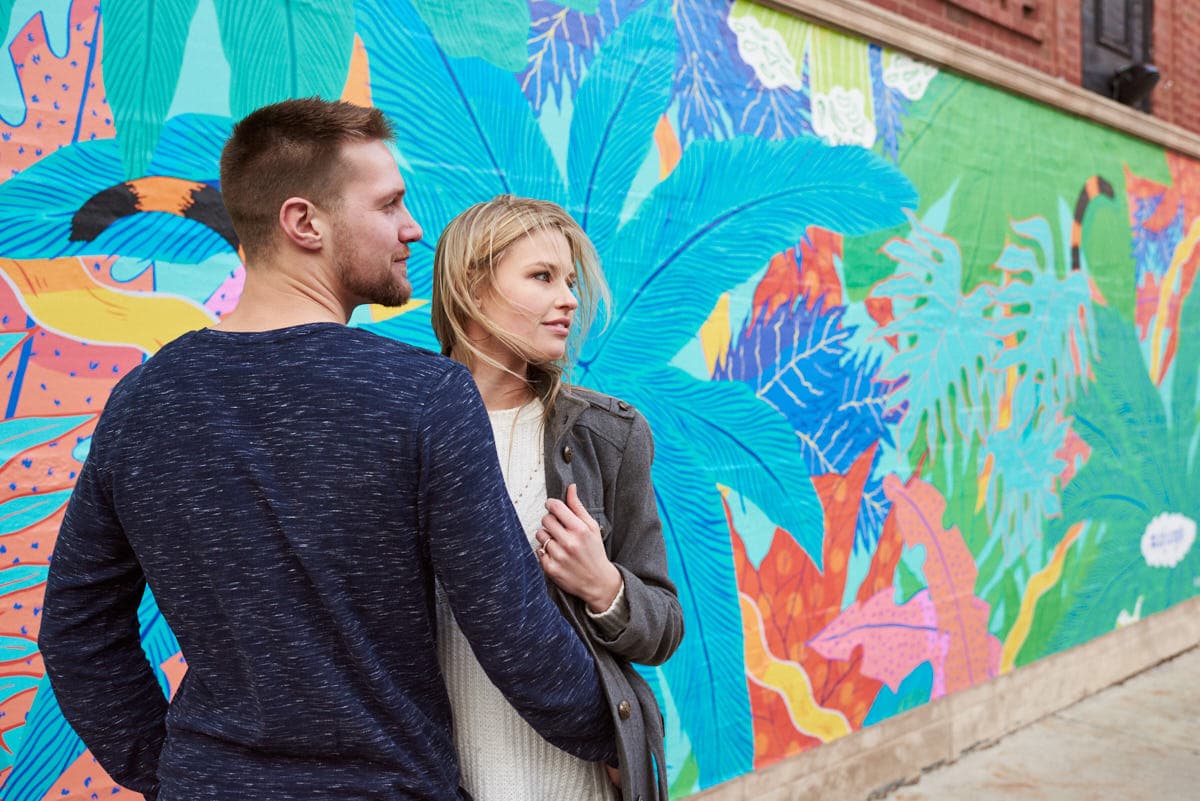Couple in front of colorful mural